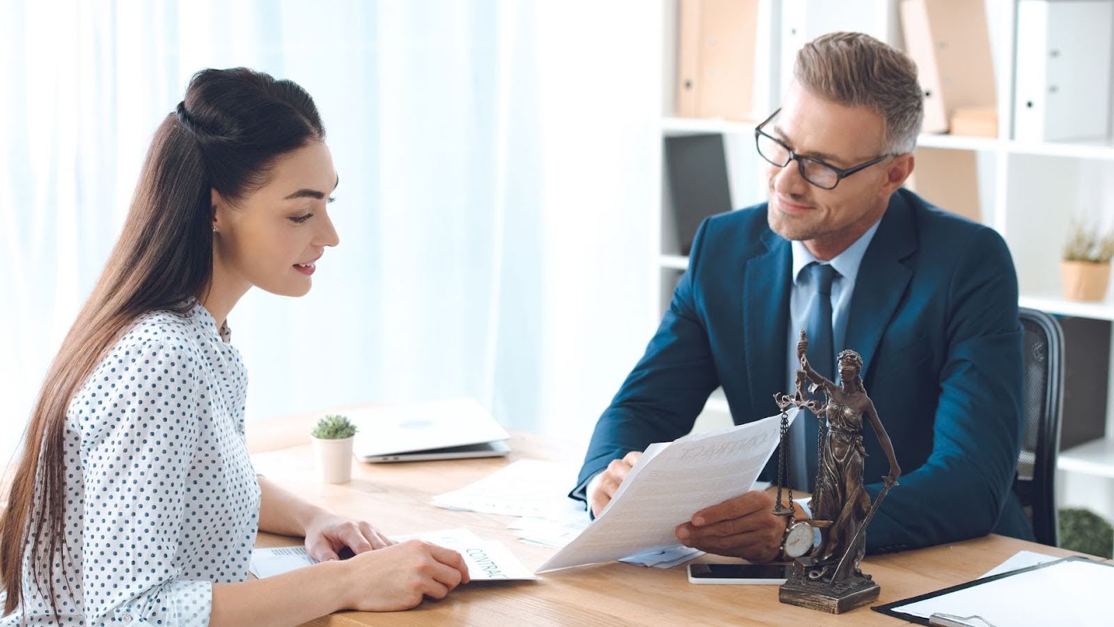 client and business attorney reviewing legal documents